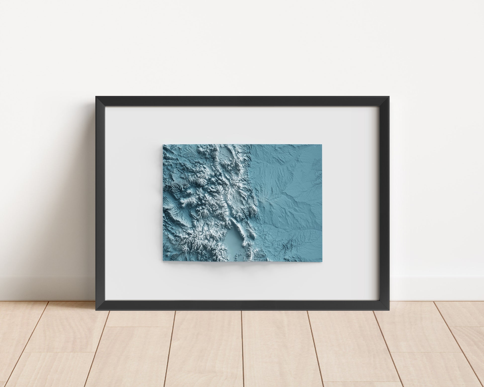 A minimalist relief map of the US State of Colorado in frame made out of pine wood. Topographic map poster for travel and geography fans.