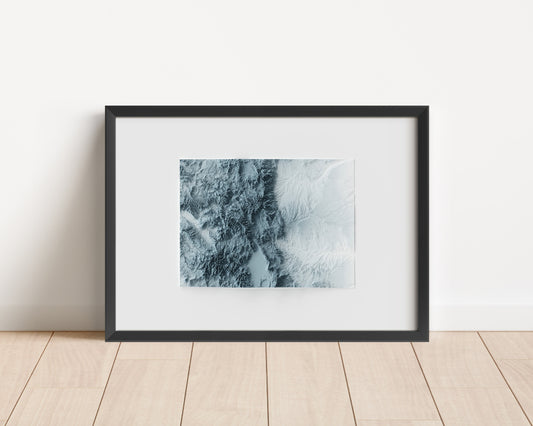 A minimalist relief map of the US State of Colorado in frame made out of pine wood. Topographic map poster for travel and geography fans.