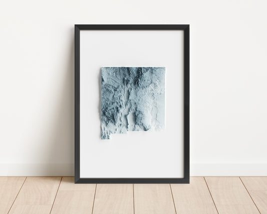 A minimalist relief map of the US State of New Mexico in frame made out of pine wood. Topographic map poster for travel and geography fans.