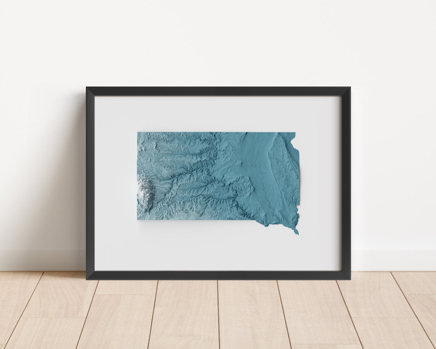 A minimalist relief map of the US State of South Dakota in a frame made out of pine wood. Topographic map poster for travel and geography fans.