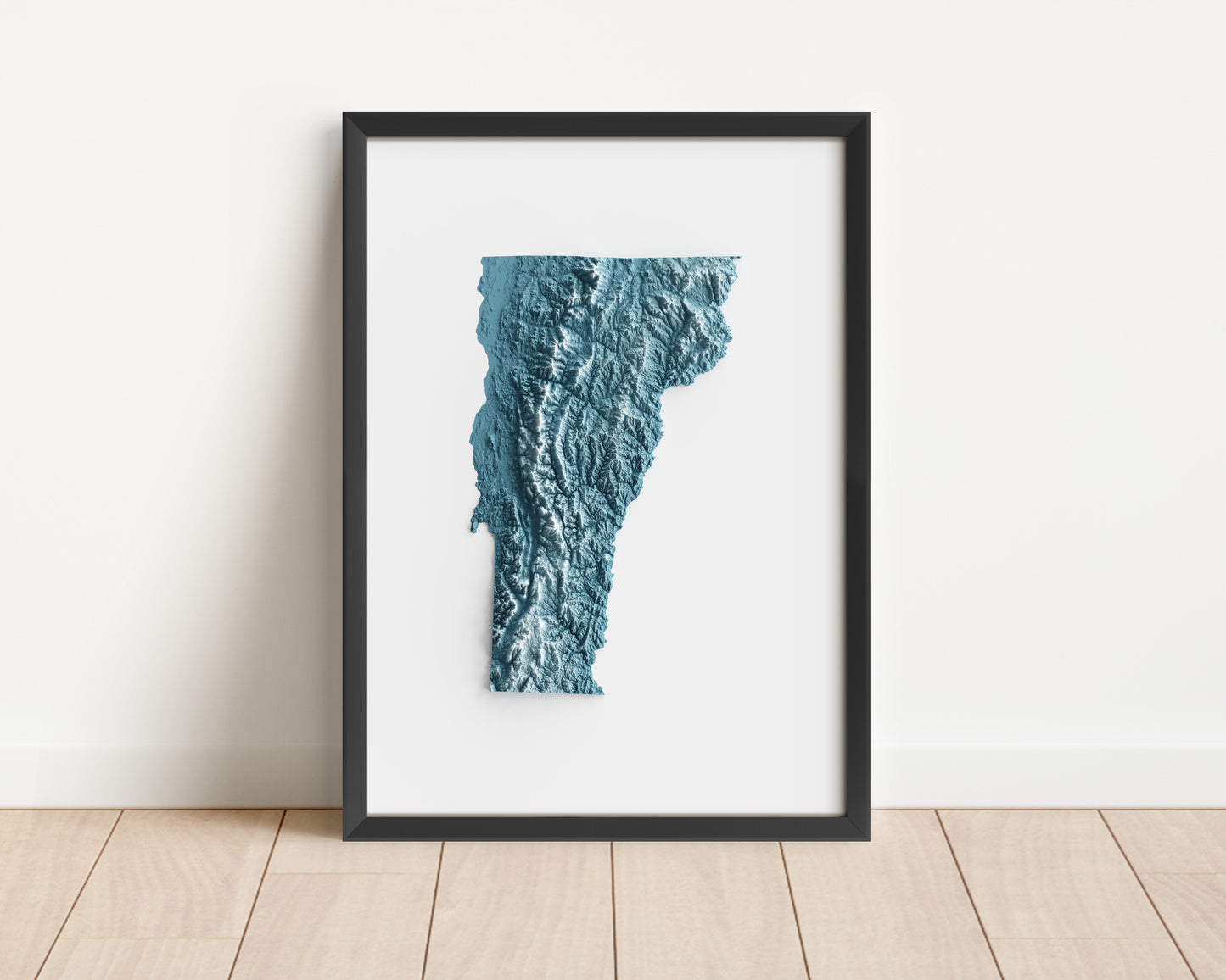 A minimalist relief map of the US State of Vermont in frame made out of pine wood. Topographic map poster for travel and geography fans.