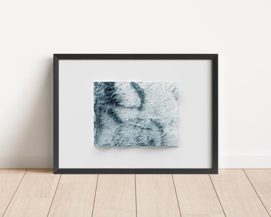 A minimalist relief map of the US State of Wyoming in a frame made out of pine wood. Topographic map poster for travel and geography fans.